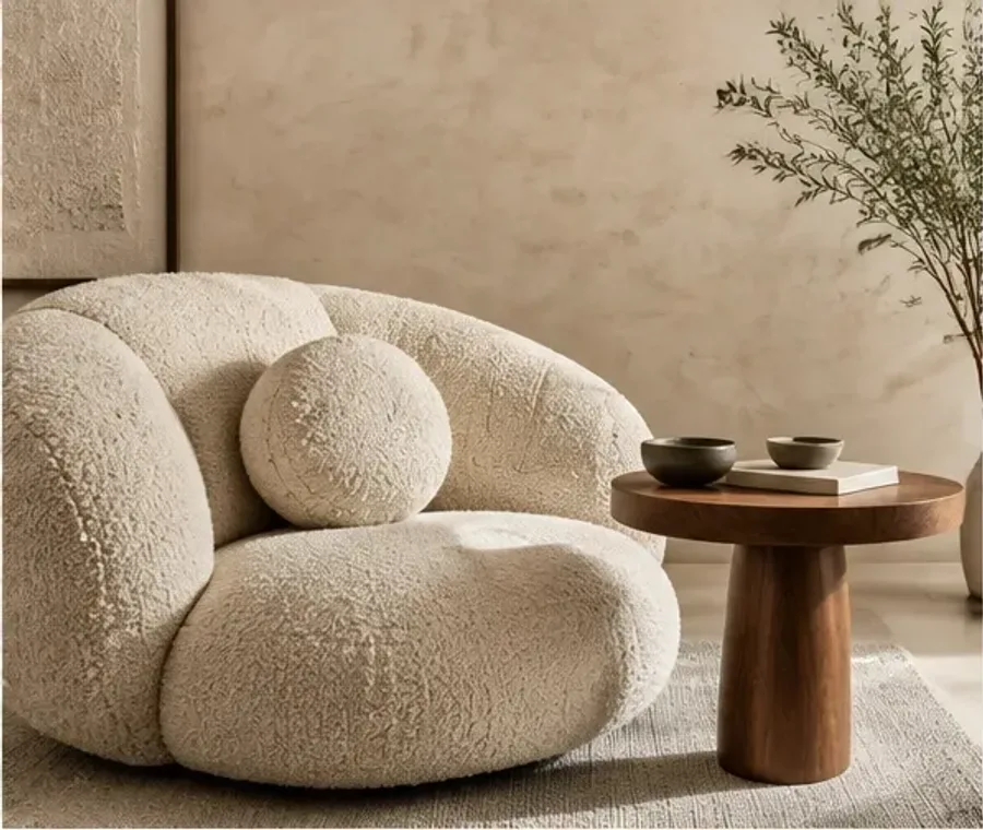 Sculptural upholstered seating in a warm neutral interior
